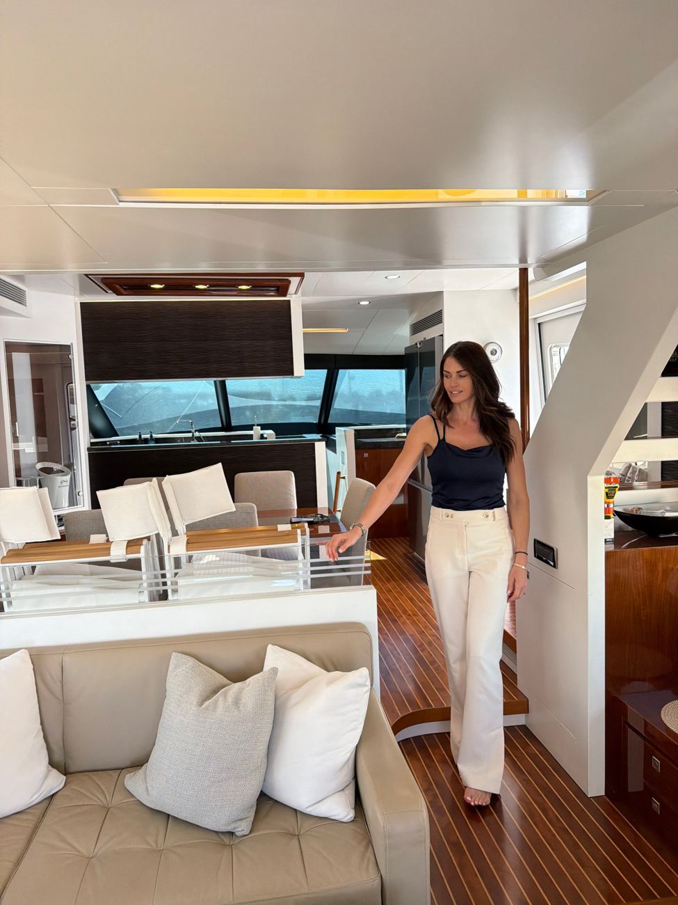 Jane McNeill walking through a yacht saloon