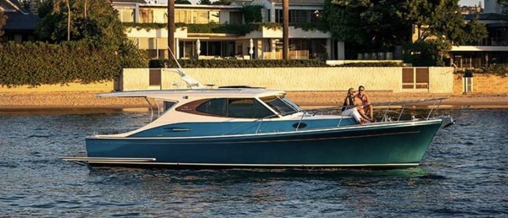 Harbour Classic 40 cruising past waterfront homes